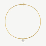 A delicate gold wire bangle necklace with a small heart-shaped clear gemstone pendant, displayed on a clean white background.