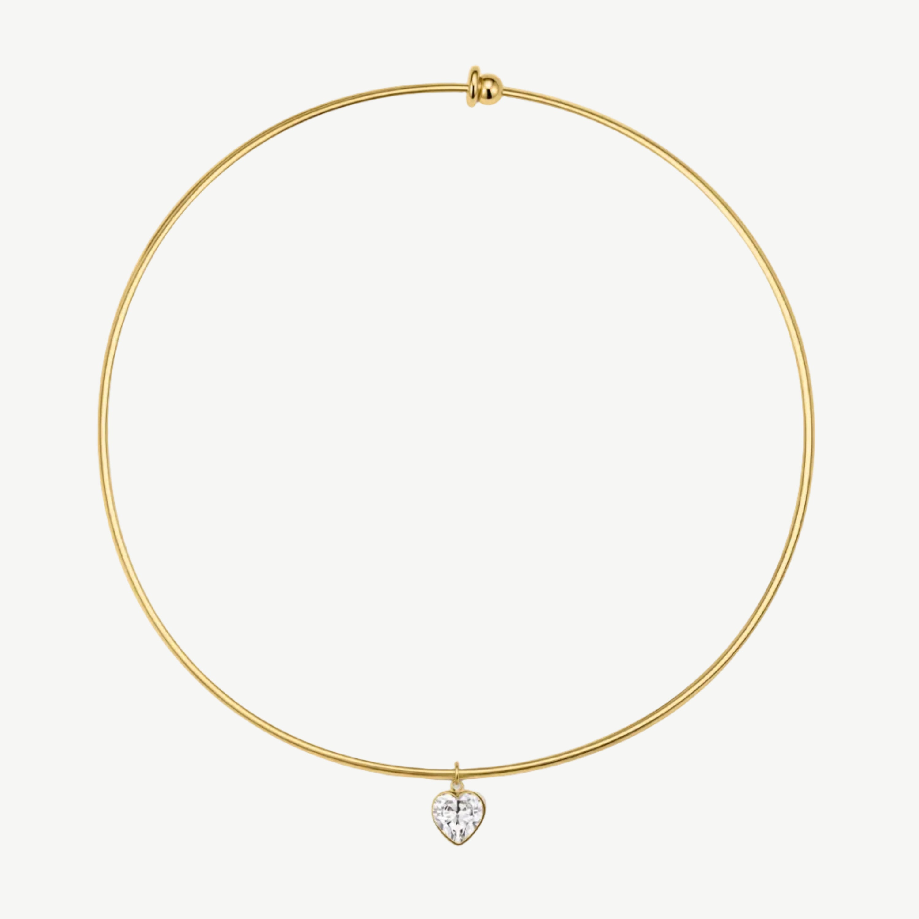 A delicate gold wire bangle necklace with a small heart-shaped clear gemstone pendant, displayed on a clean white background.
